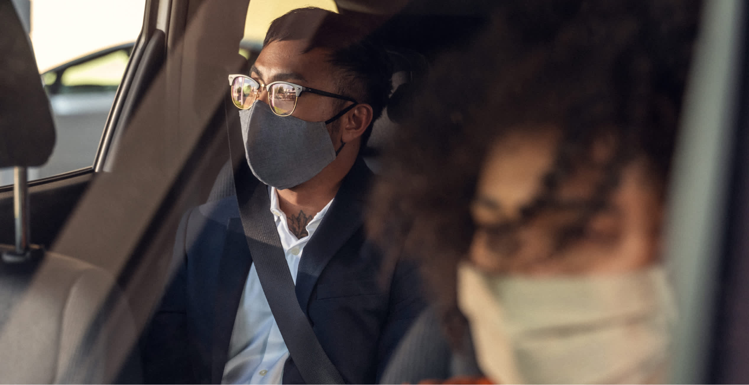 a passenger in the back seat masked up